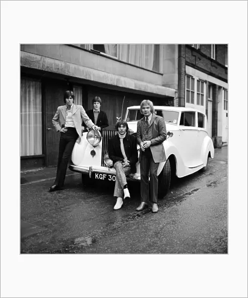 The Bee Gees examine an early christmas present from agent Robert Stigwood