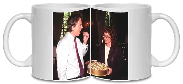 British Prime Minister Tony Blair accepts a chocolate from Judy Mallaber MP for Amber