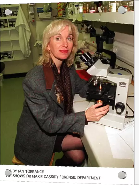 Pathologist doctor Marie Cassidy sitting at microscope in laboratory In charge as
