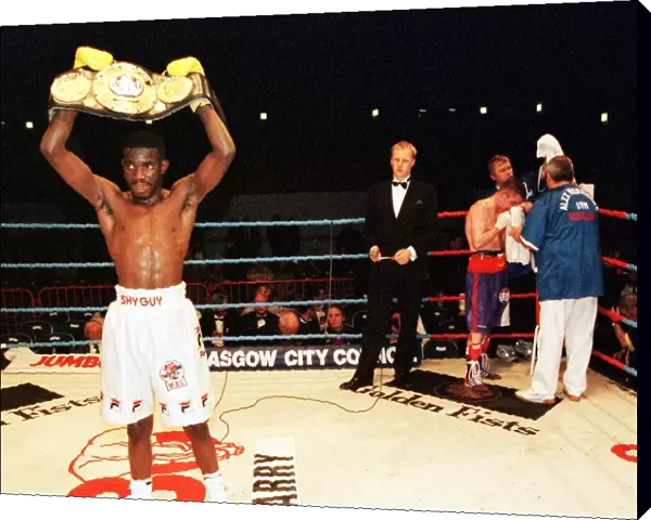 Cassius Baloyi lifts the WBU featherweight championship belt June 1999