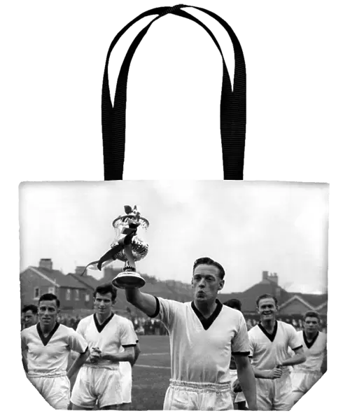 Giant-killersO skipper Frank Marshall holds the beribboned Cup aloft after