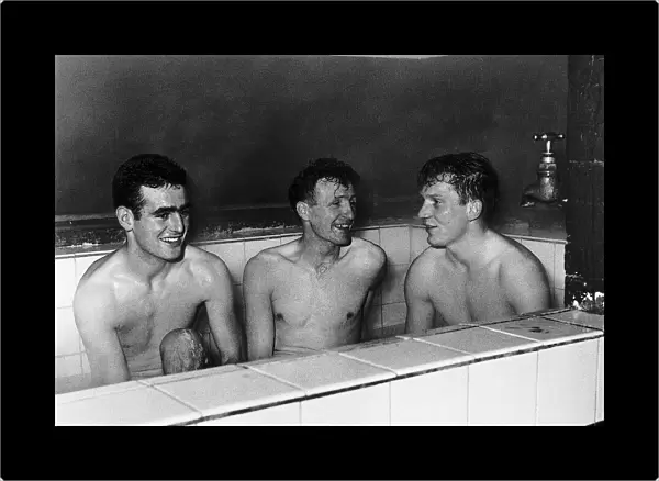 Tony Devreux, Gordon Henry & Dick Renwick of Aldershot FC enjoy a good hot bath