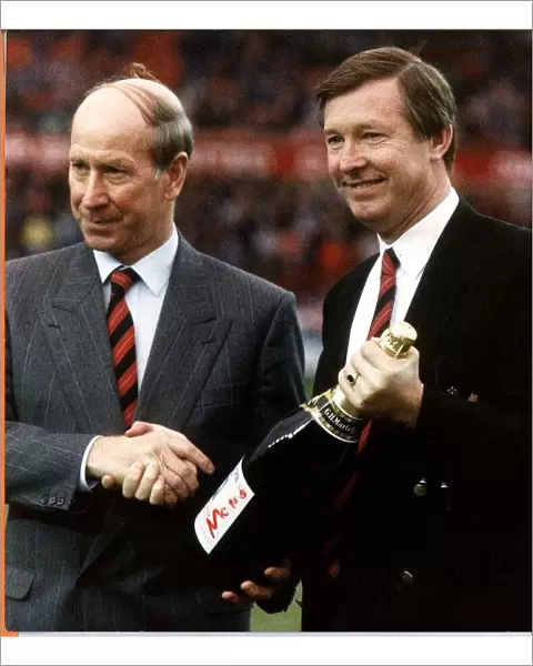 Sir Bobby Charlton shaking hands with Manchester United manager Alex Ferguson after