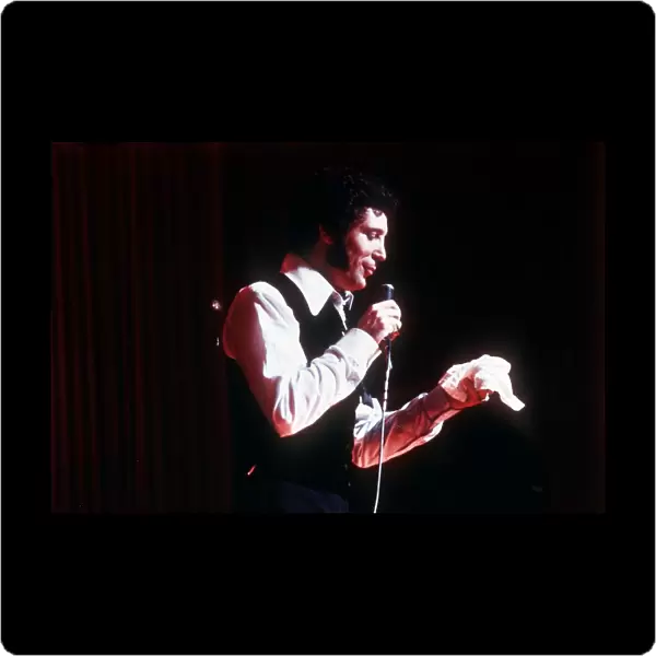 Tom Jones singer singing microphone open necked shirt waistcoat hankerchief