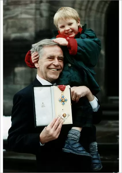 Magnus Magnusson TV presenter Master Mind holding medal honorary Knighthood holding