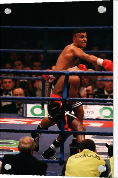 Prince Naseem Hamed lands a punch on Tom Boom Boom Johnson in their IBF world feather