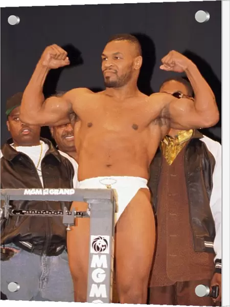 Mike Tyson flexes his muscles at the weigh in. Ready for the fight against Frank Bruno in