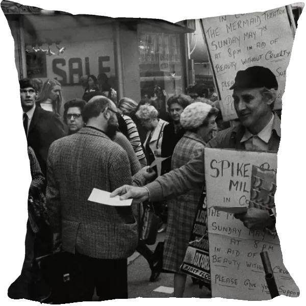 Spike Milligan actor with sandwich board handing out notices for a concert in which he