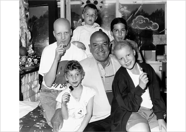 Telly Savalas actor with young cancer patients in June 1989 at the Royal Marsden Hospital