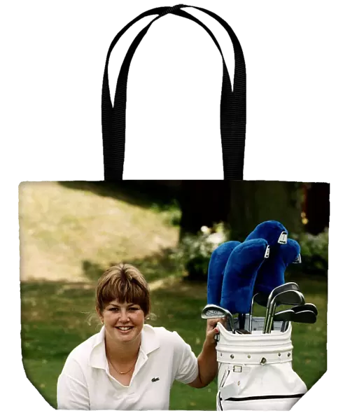 Joanne Furby Golf player crouching beside gold bag