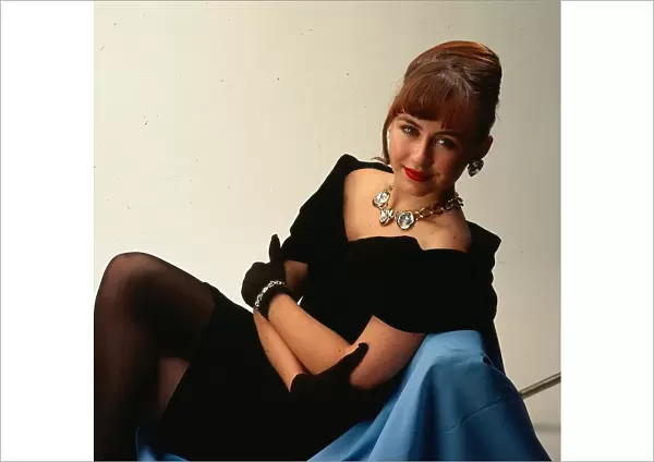 Actress Mouche Phillips November 1990 wearing black off the shoulder dress