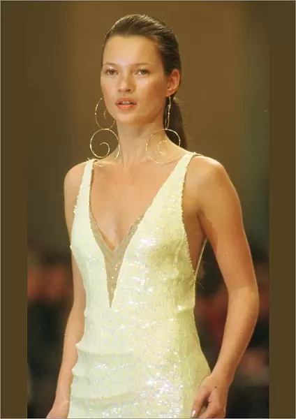 Kate Moss models for Chanel at Paris Fashion Week 1999 Wearing a low cut dress with
