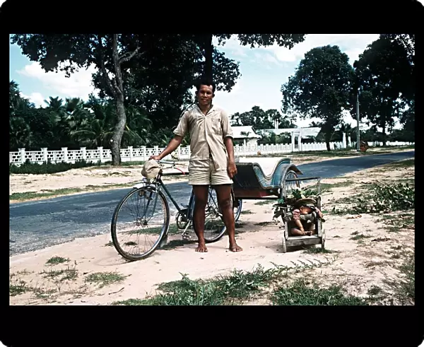 Sleeping child and bicycle rickshaw driver near Angkor Wat North West Kampuchea Cambodia