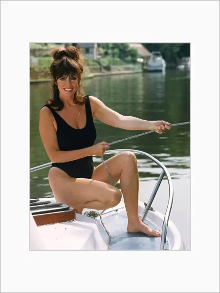 Vicki Michelle actress from Allo Allo cools off on a boat by the river during a spell of