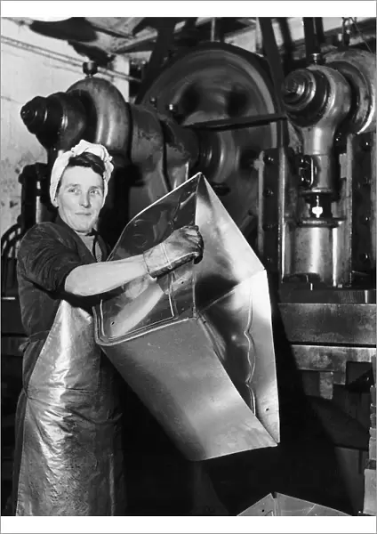 Lily Hill at her giant press stamping out the metal foundations of baby prams at a