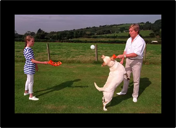 William Roache Actor playing with his daughter and their dog in the back garden