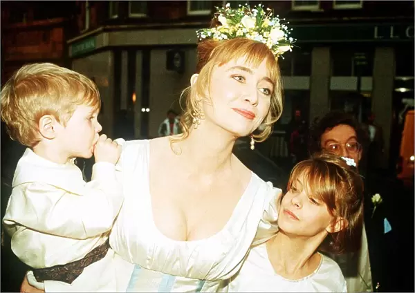 Lysette Anthony actress at wedding with page boy and bridesmaid