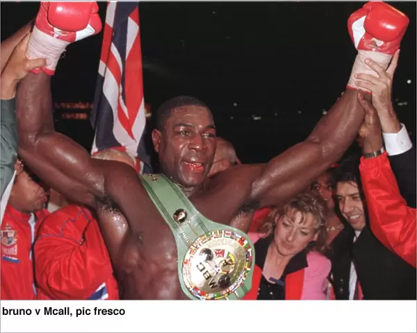 Frank Bruno raises his arms in jubilation after defeating Oliver McCall at Wembley
