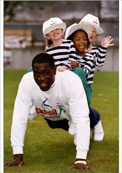 Frank Bruno boxer doing press ups with children on his back