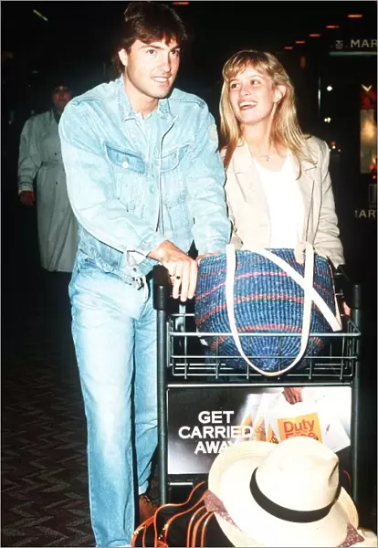Actor Nick Berry arrives at Heathrow Airport with model Rachel Roberts May