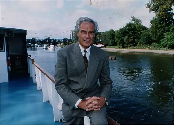 Robert Kilroy Silk former MP - TV Presenter on boat beside river grey suit