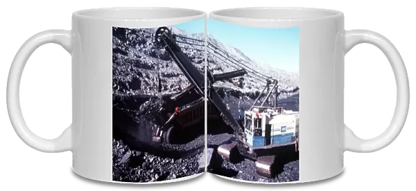 Nine centimetre bucket filling 110 tonne haul unit with black coal at Ravensworth mine