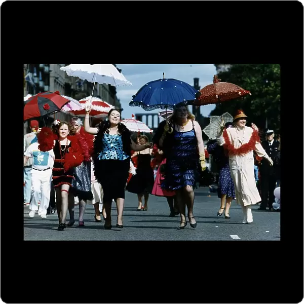 Women dressed as 1920s flapper girls walking down a street during the Edinburgh
