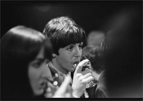 Paul McCartney enjoying a drink of wine as he attends the Ready Steady Go Rediffusion