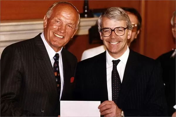 Henry Cooper (L) ex-British and Commonwealth Heavyweight boxing champion receives a