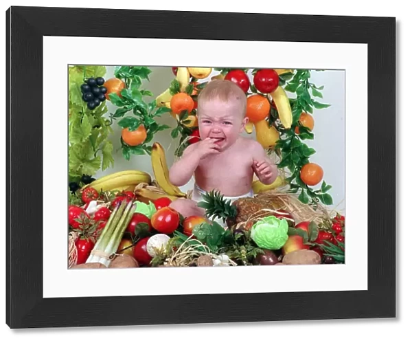 Sam Stewart baby wearing nappy surrounded by fruit and vegetables September 1992 fingers