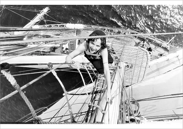 15 year old Belinda Pickard climbs the foremast rigging as the sail training ship