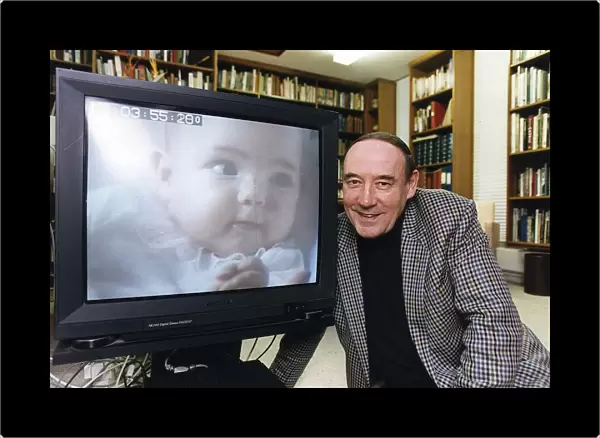 Desmond Morris anthropologist tv presenter baby watching at his home in Oxford