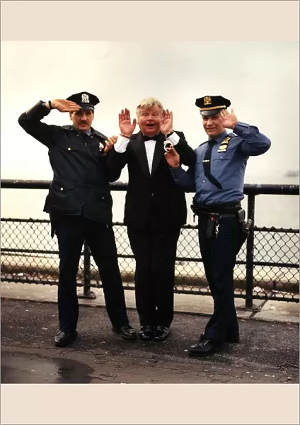 Benny Hill actor and comedian is hancuffed in a send up of the TV Programme '