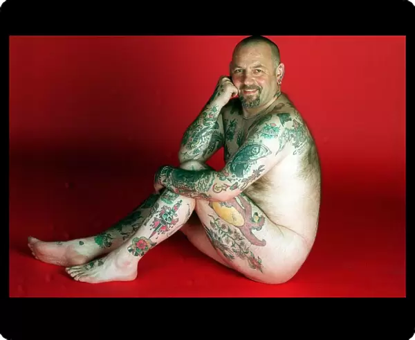Gavin Boyra - Tattoo man sitting on floor naked tattoos on legs arms and back. April 1997