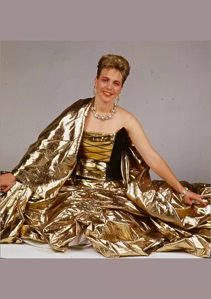 Hazel Irvine TV presenter September 1988 wearing gold evenign sress sitting on floor
