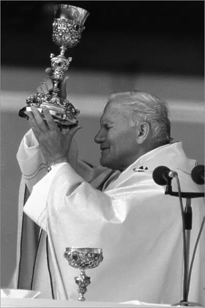 Pope John Paul II blessing the wine during an open air mass held at Wembley Stadium