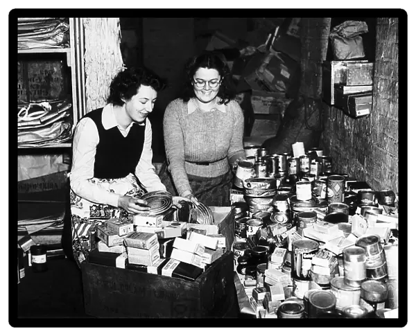 Women pack cans of food to be sent to troops in Europe during WW2 1944