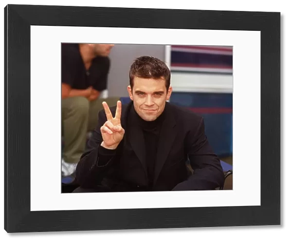 Robbie Williams relaxes on the set of his lastest video being shot in the grounds of