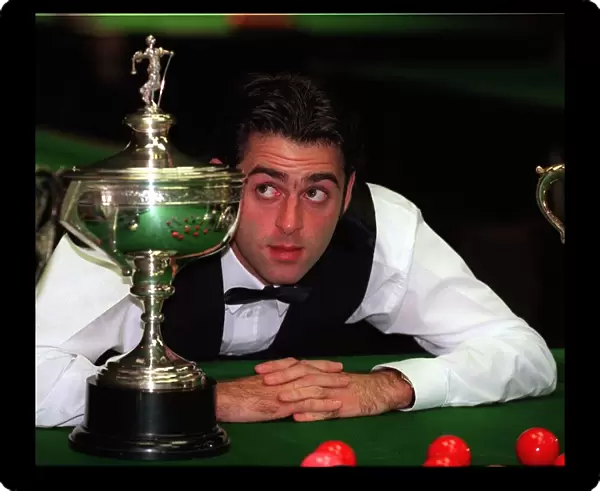 Ronnie O Sullivan snooker player September 1997 Looks at World Championship trophy