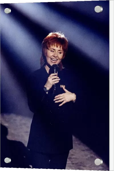 Lulu singer & actress singing at a Royal Command Performance on stage with microphone