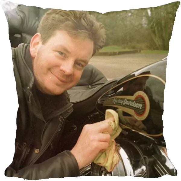 John Gordon Sinclair actor polishing his Harley Davidson Electra Glide motorcycle