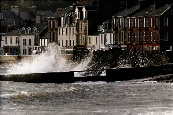 Waves crash against a wall at Millport in Scotland after heavy winds caused the sea to