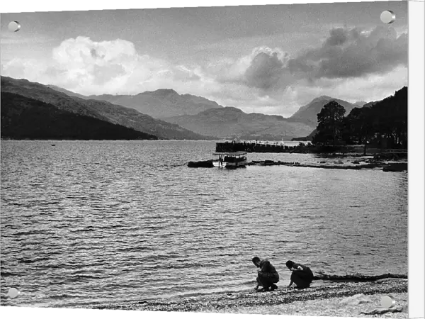 Views A pier on Loch Lomond boats people on shore