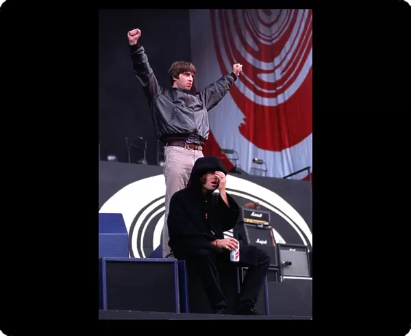 Liam and Noel Gallagher greet the crowd during the Oasis concert at Balloch Country Park