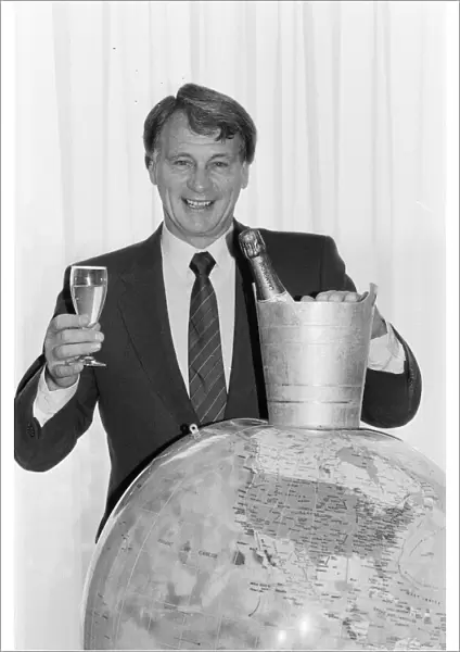 England manager Bobby Robson holds a glass of champagne in one hand looks forward to