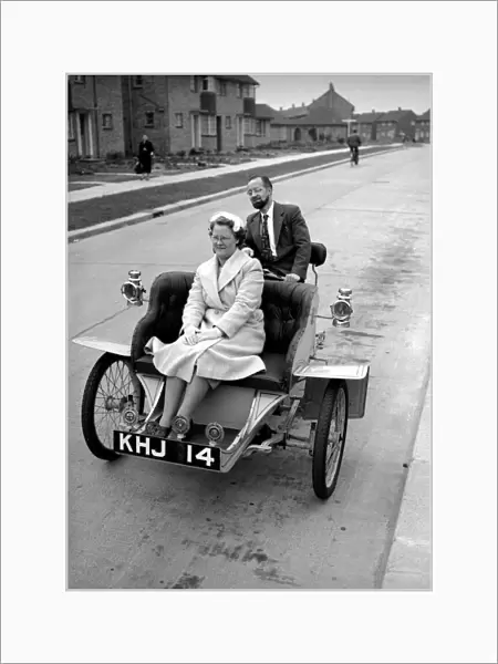Laurence Mathew sitting in his veteran car with his wife driving behind May 1956