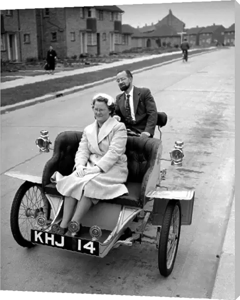 Laurence Mathew sitting in his veteran car with his wife driving behind May 1956