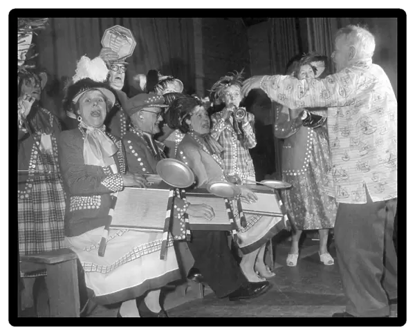 Pearly kings and queens play the washboard and other musical instruments during a concert