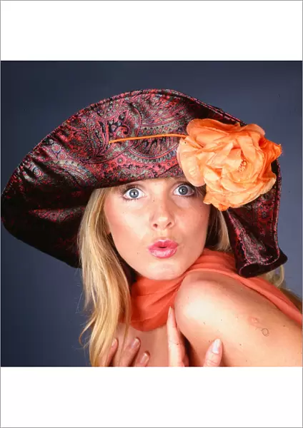Hat Fashion Model wears Paisley patterned hat with orange flower November 1989