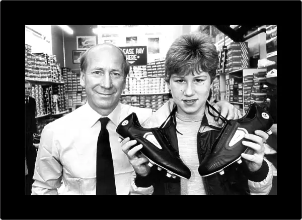 Bobby Charlton with budding soccer star paul Barrett when he chose a pair of football